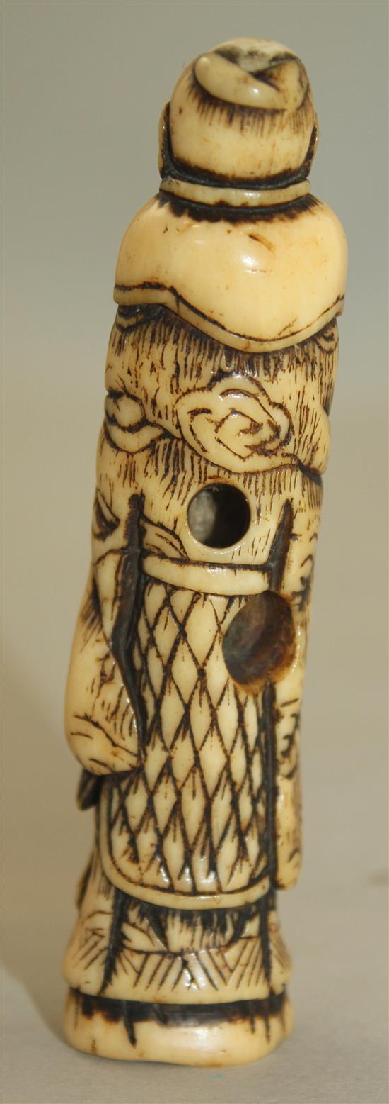 A Japanese stag antler netsuke of a standing sennin, Edo period, 9.8cm